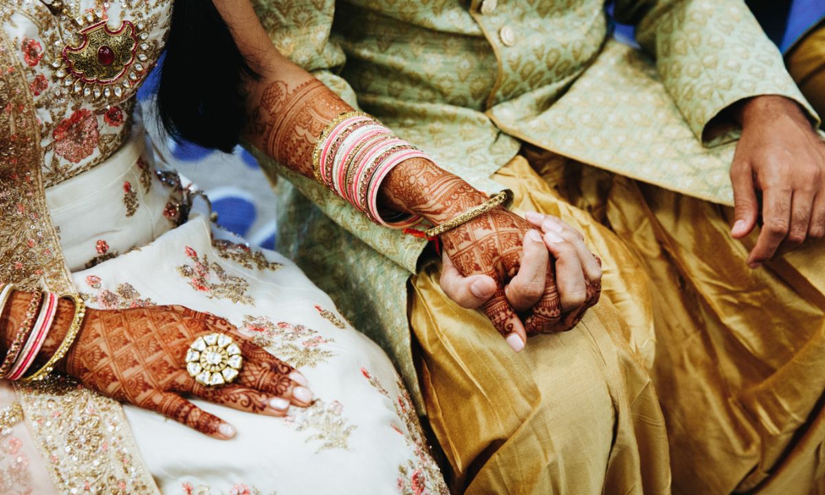 Indian couple are holding hands for engagement ceremony